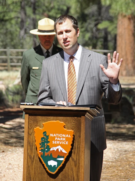 a man giving a speech from behind a podium