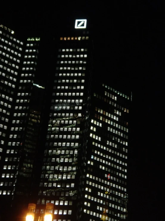 two large buildings in front of the city lights