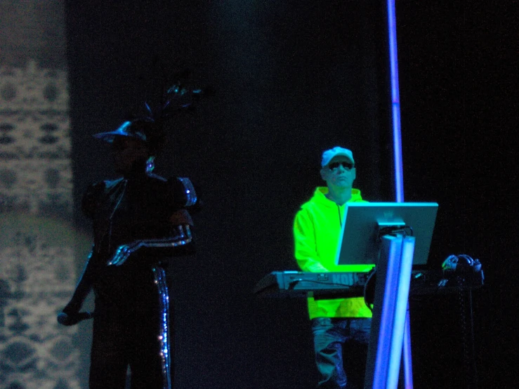 a man standing on a stage while looking at a computer