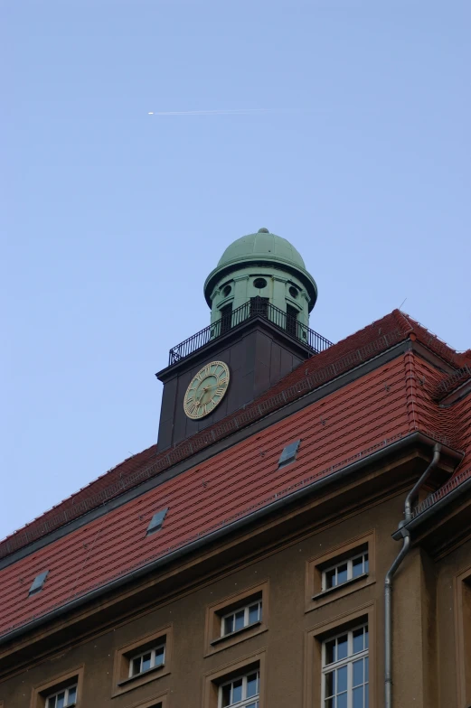 a view from below looking up at an ornate building and a clock