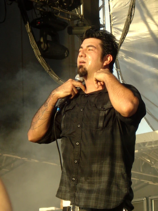 a man with microphone singing on stage