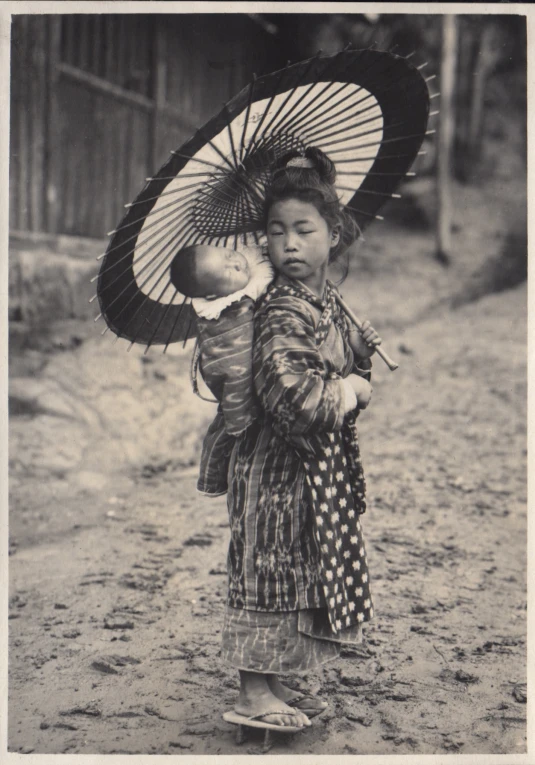 the child is holding an umbrella outside while wearing a polka dot outfit