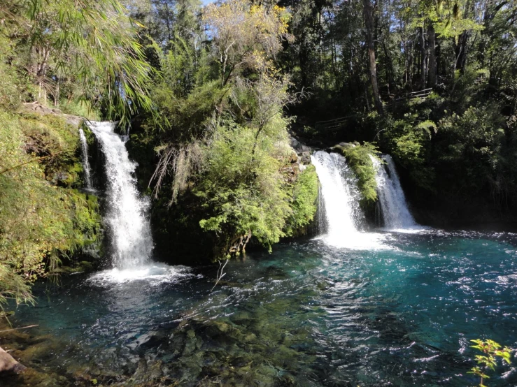 the water that is running over rocks is crystal blue