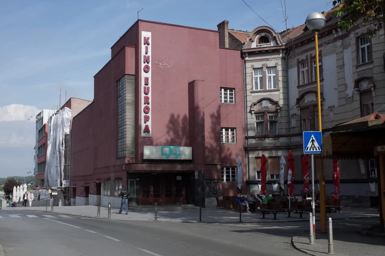 the theater on the side of a street is empty