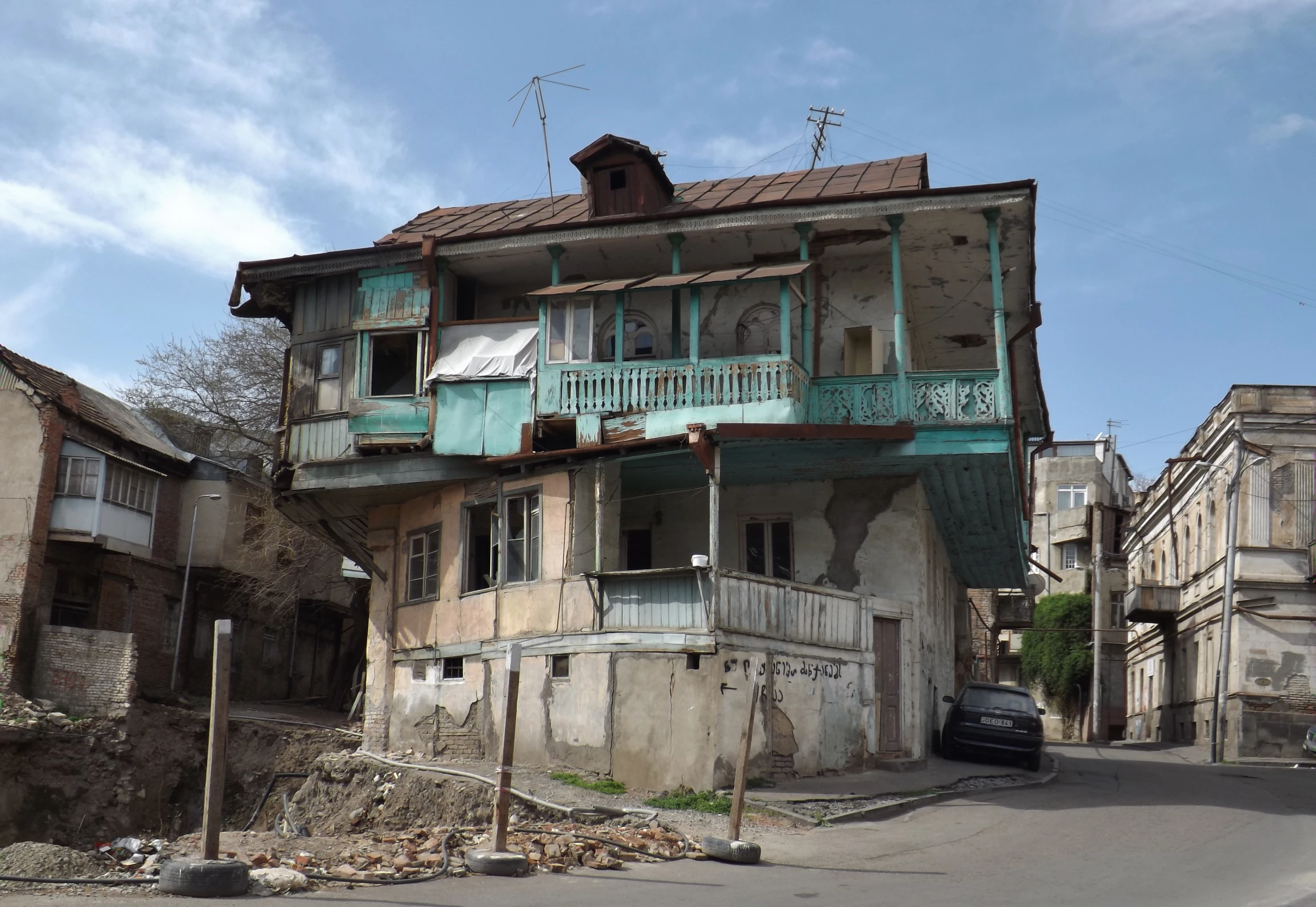 an old and run down street with cars parked on it