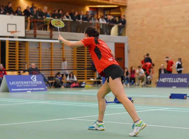 a person holding a tennis racket on a court