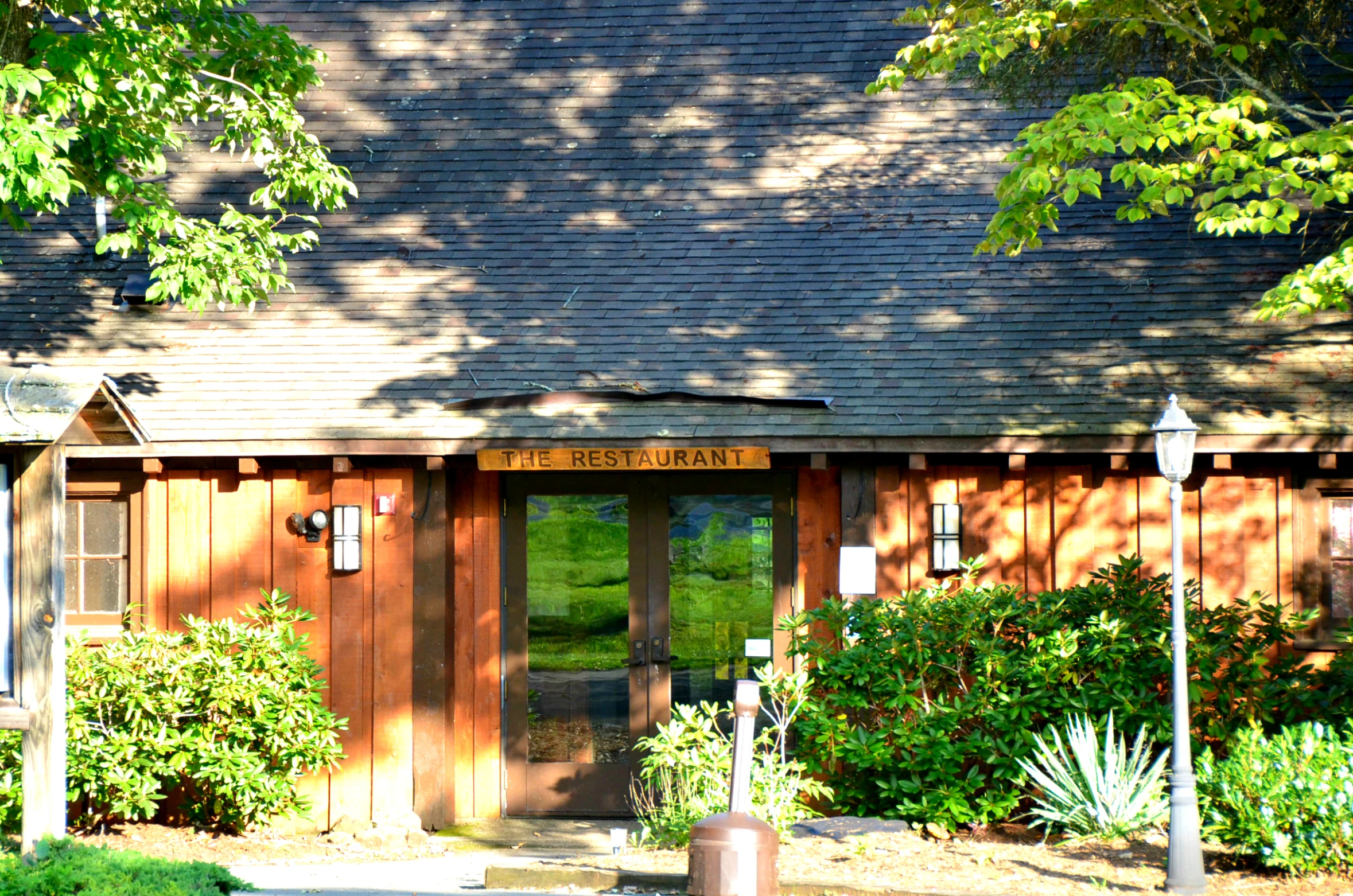 the entrance to the lodge that is located on a hill