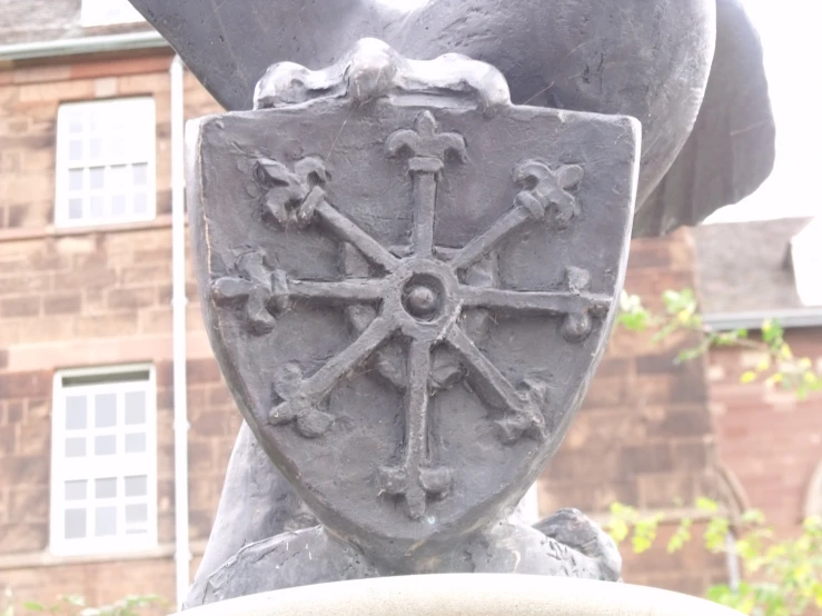 an ornate stone statue of a knight in front of a building