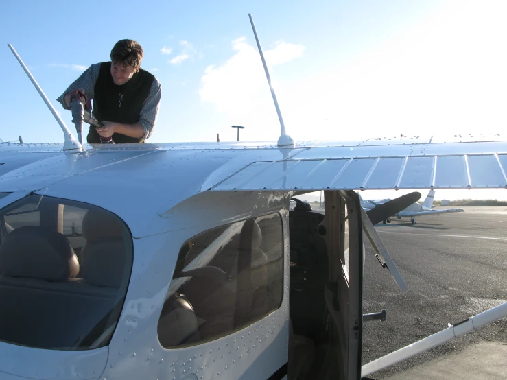 man in front of plane with clear glass windows