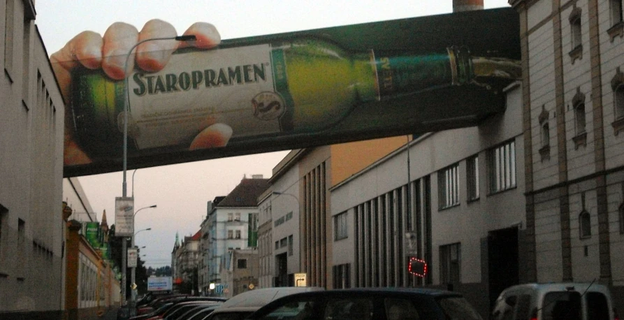 a large sign above a busy street has advertising on it
