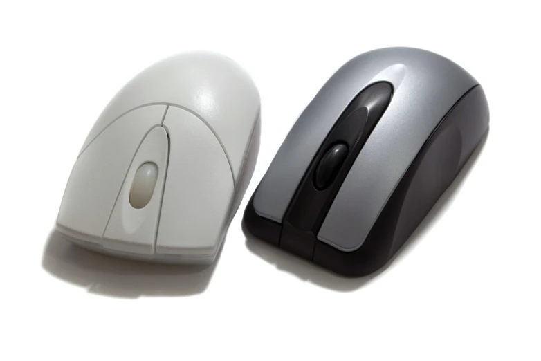 two computer mouses with a white and gray mouse top one on the left