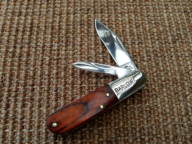 a multi - tool knife that is lying down on the ground