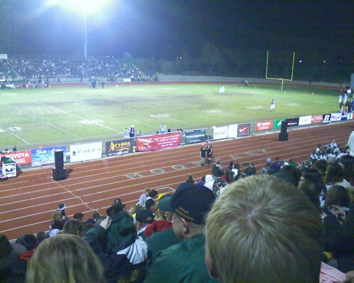 a baseball stadium full of people on a dark night