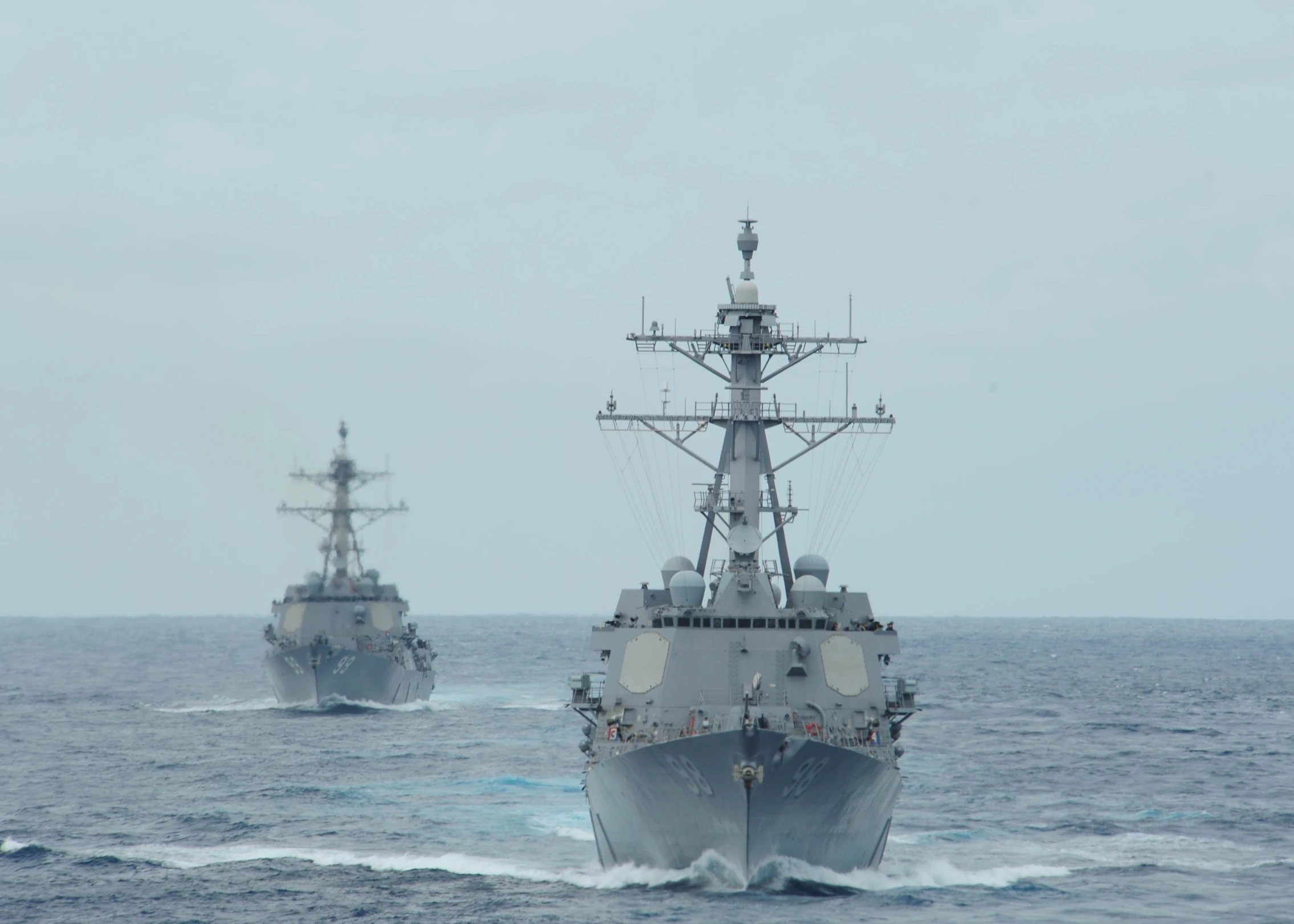 two military ships in the middle of the ocean