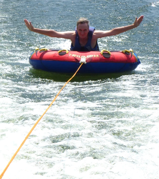 the man is riding on the raft down the water