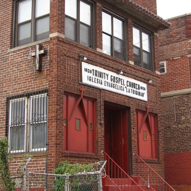 a red brick building has a white and black sign in front of it