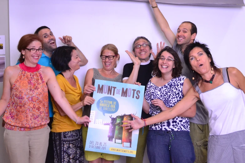 a group of people are standing in front of a sign