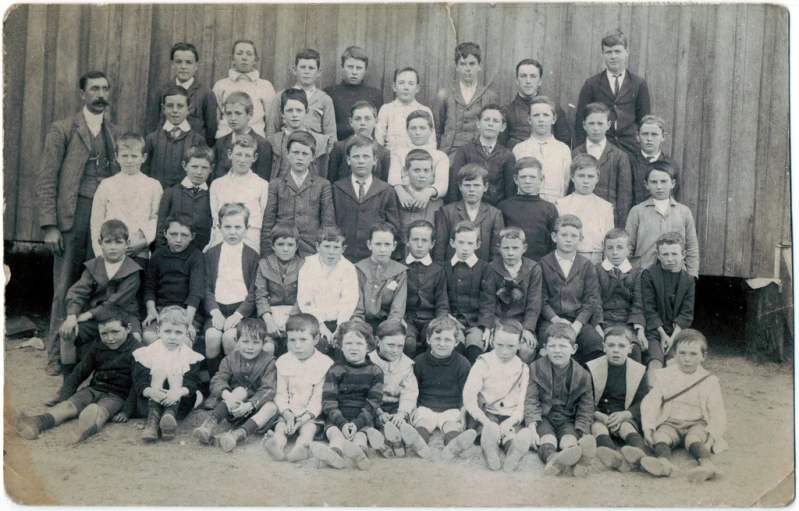 an old school picture shows many children dressed in suits