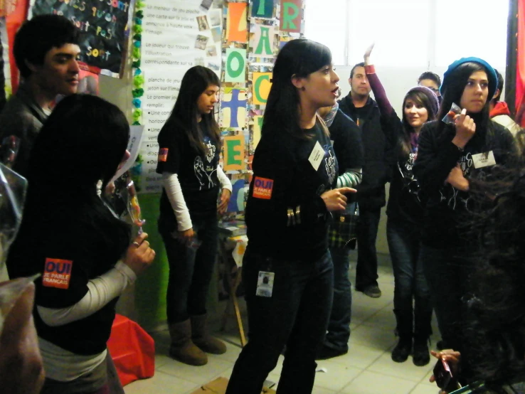 several people are talking while one woman stands in front of them