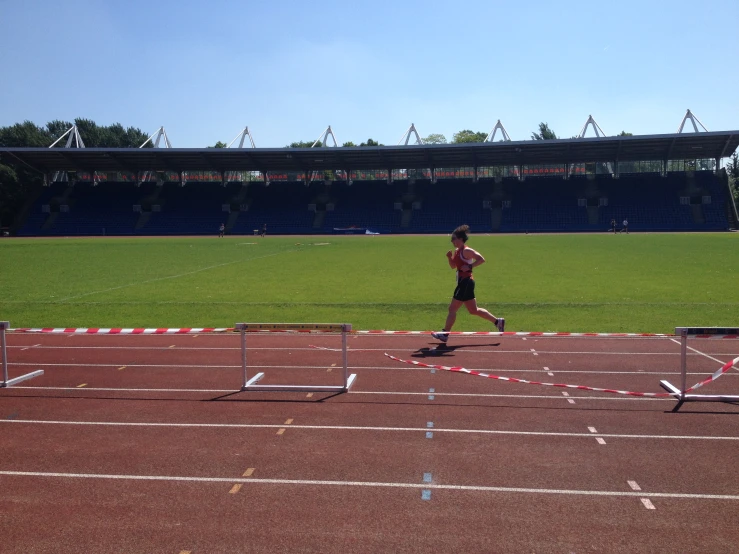 man jogging on an empty track during the day