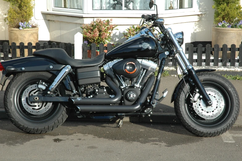 a motorcycle sits in front of some plants