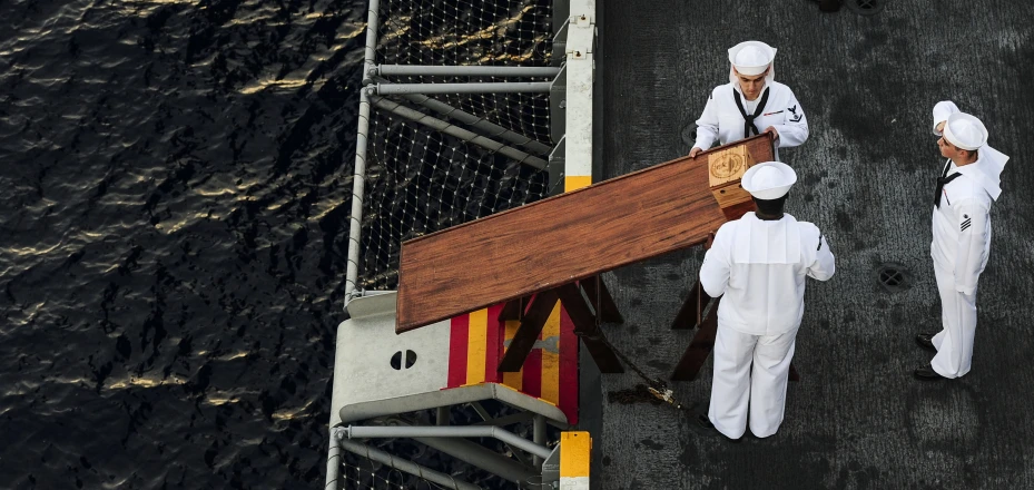 a boat is floating away with three chefs