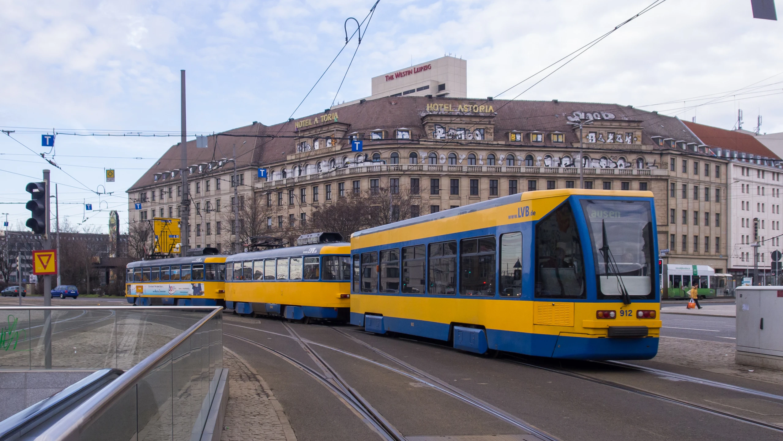 a yellow and blue bus on a road