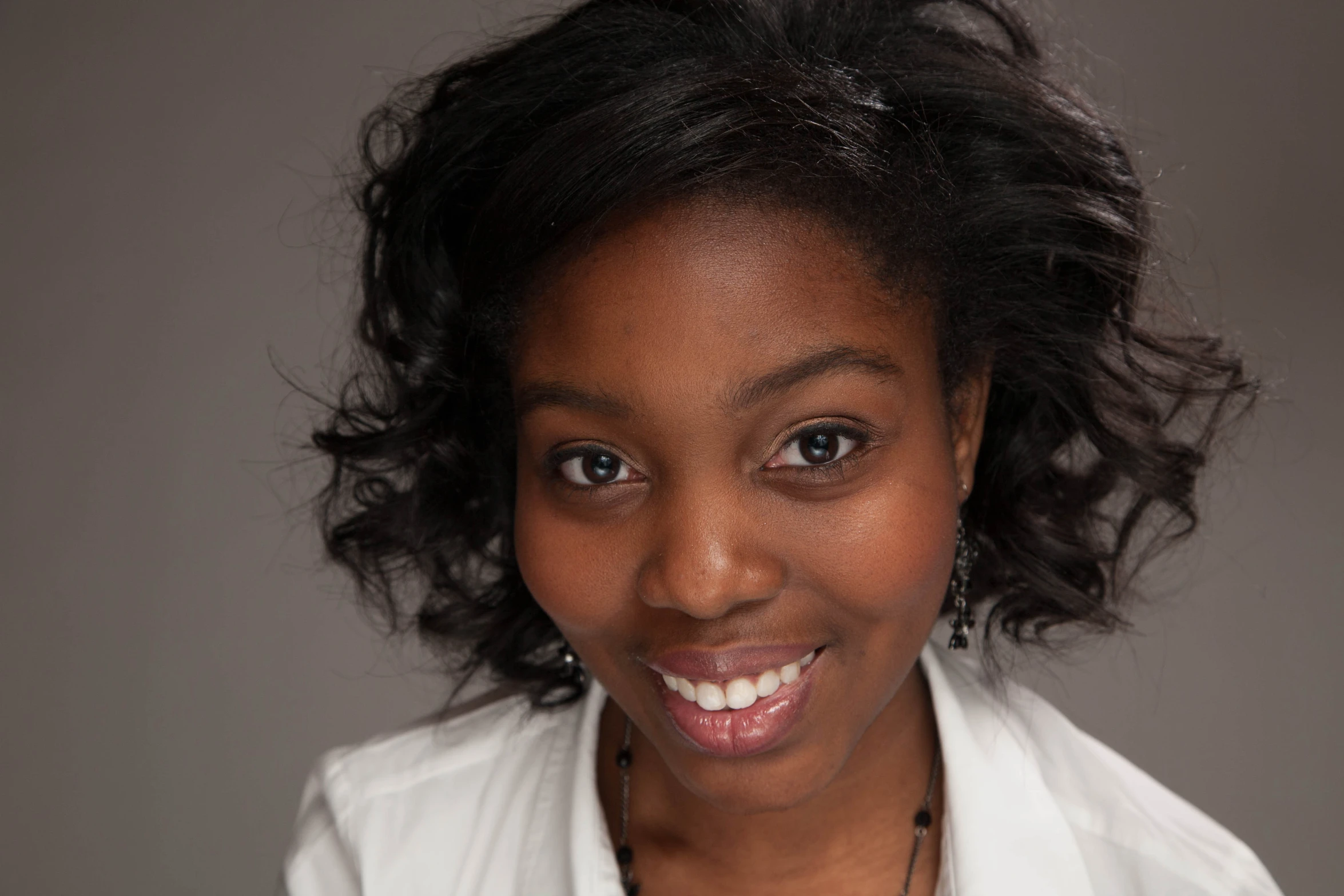 a close up of a young woman smiling