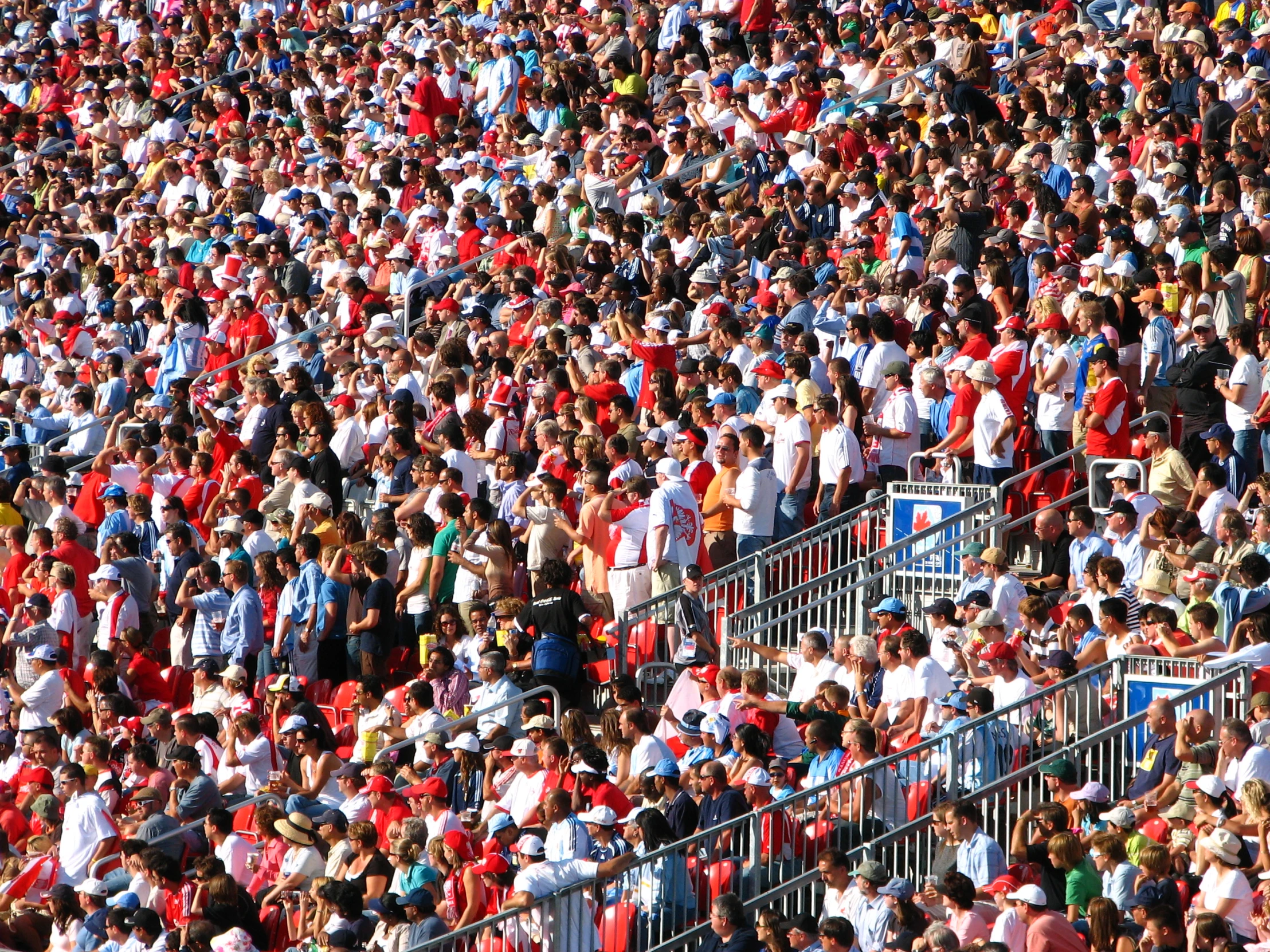 large crowd of spectators watching a baseball game