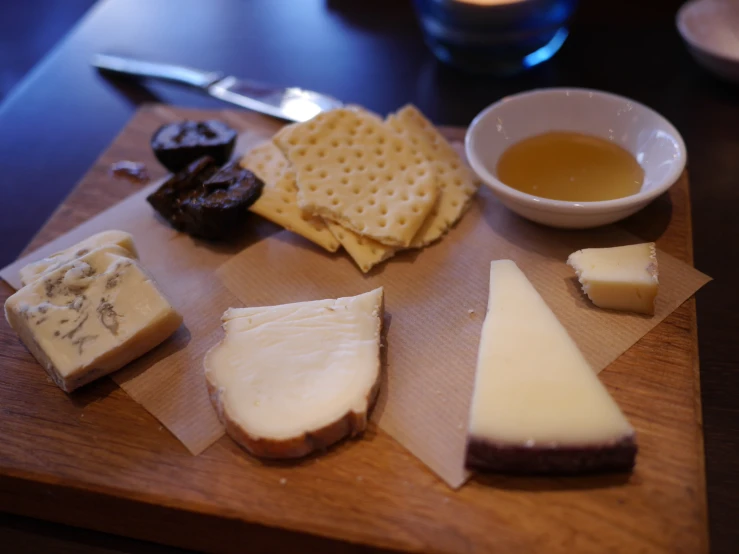 the board is loaded with several types of cheese and ers