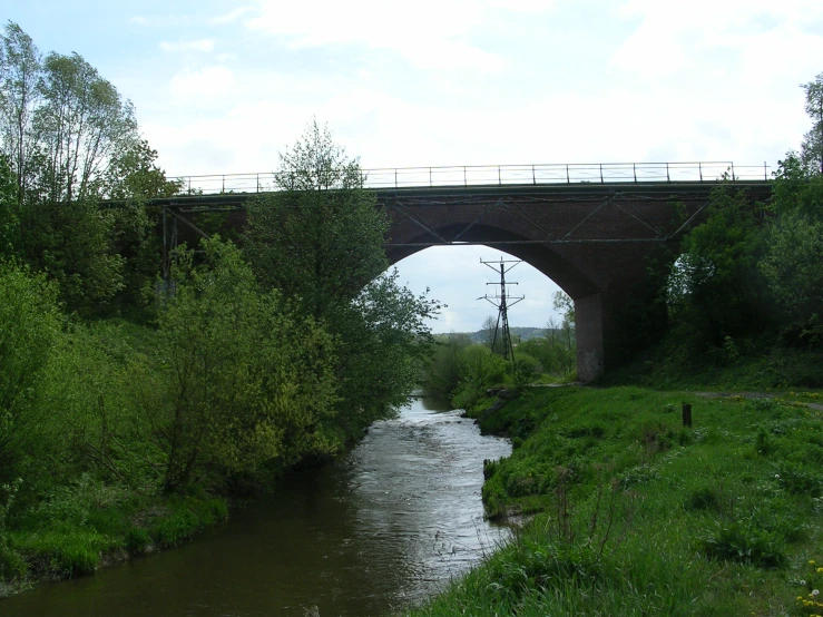 an old train bridge crossing over a river