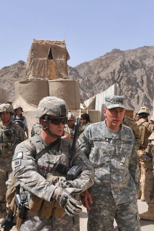 a man in a military uniform talking to another man