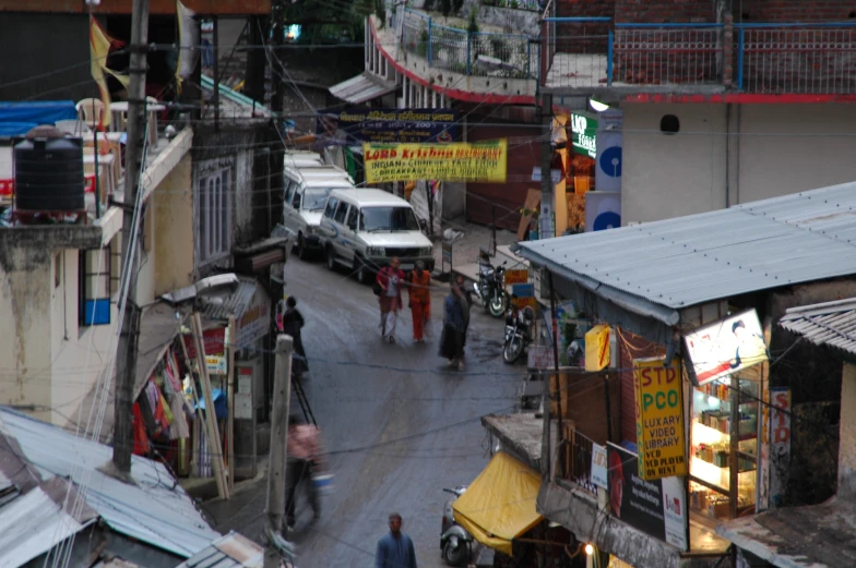 people walk down a small alley way in the city