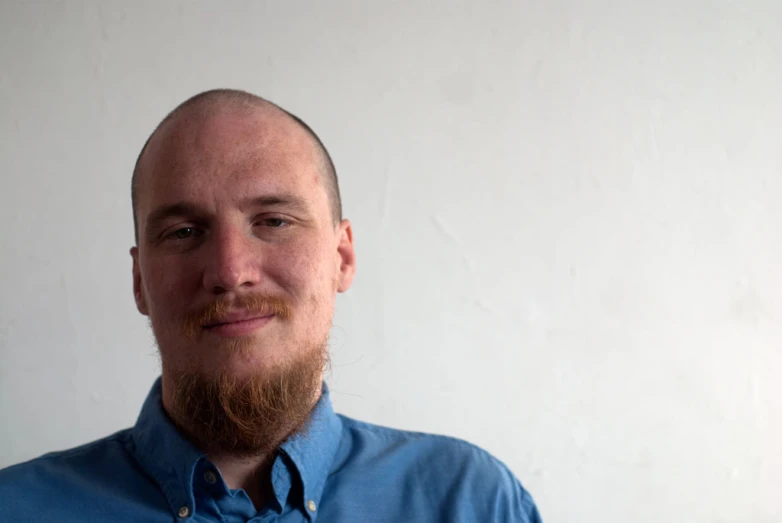 a close up of a man with a bald head