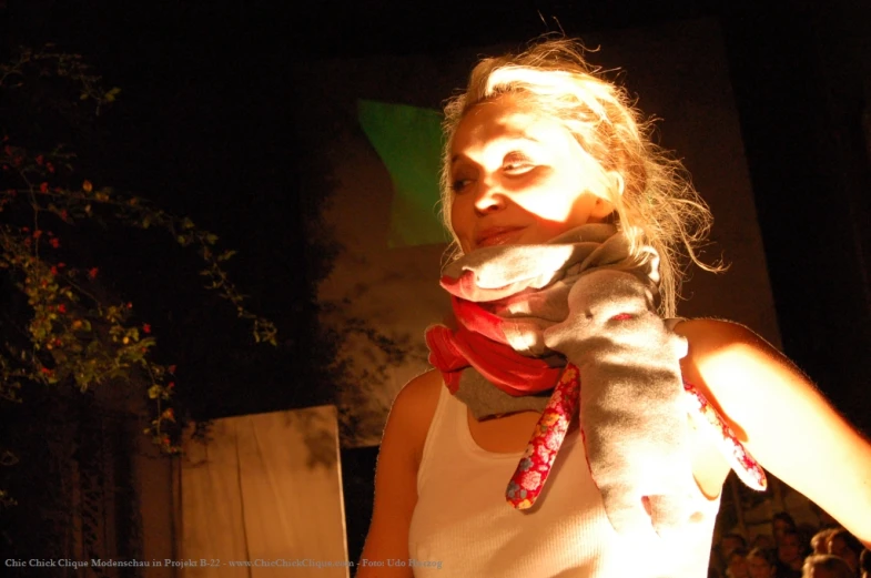 a young woman wearing a scarf on top of her neck