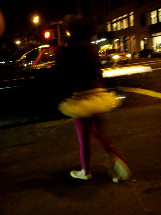 a girl is walking down the street with a yellow umbrella