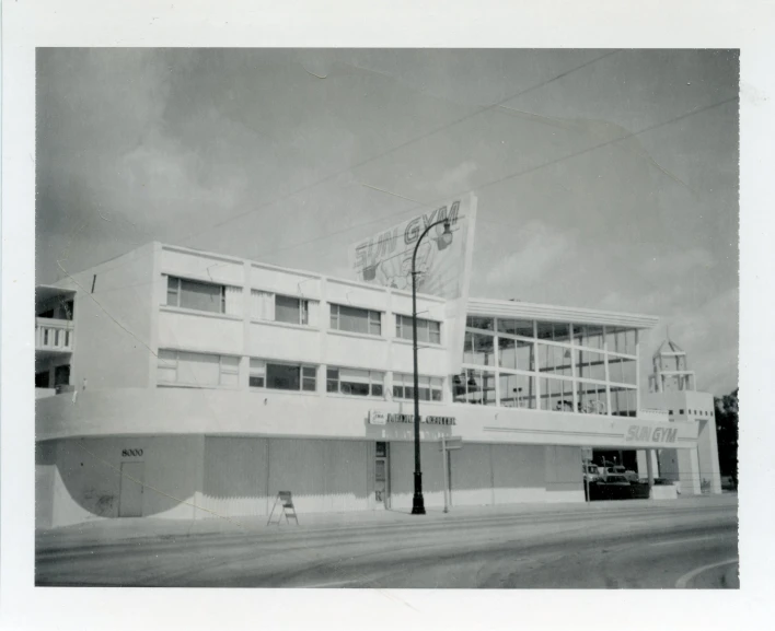 a white building sits behind a traffic light on a street corner