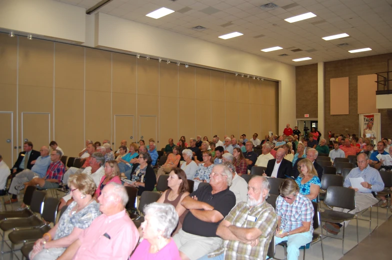 a large group of people sitting in chairs