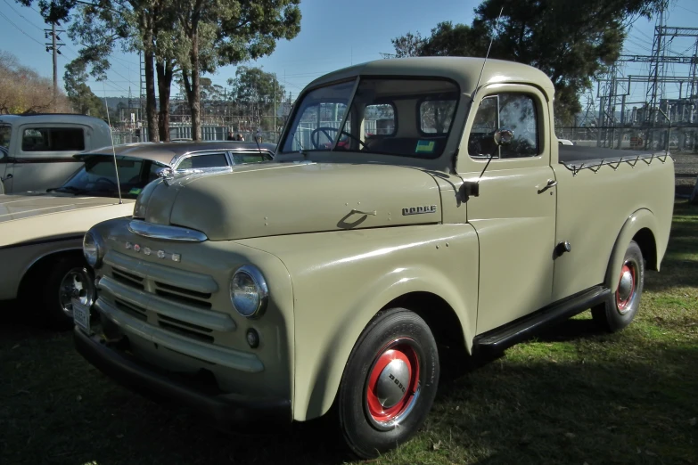 the old truck is parked in the field