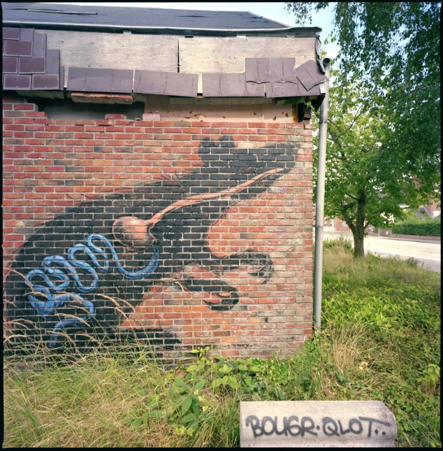 a brick wall with a painted horse and sign on it