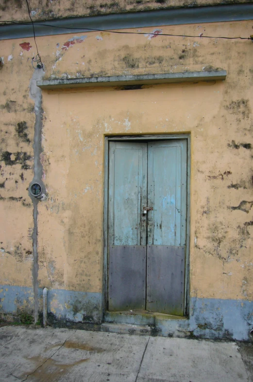 the old door is painted blue on the wall