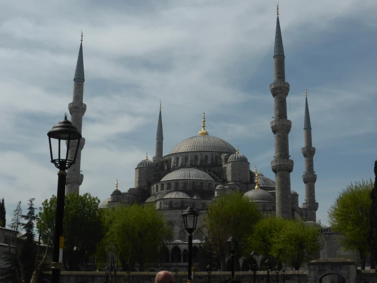 a large building with two domes in front of a street light