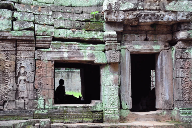 an elephant is sitting inside of some stone buildings