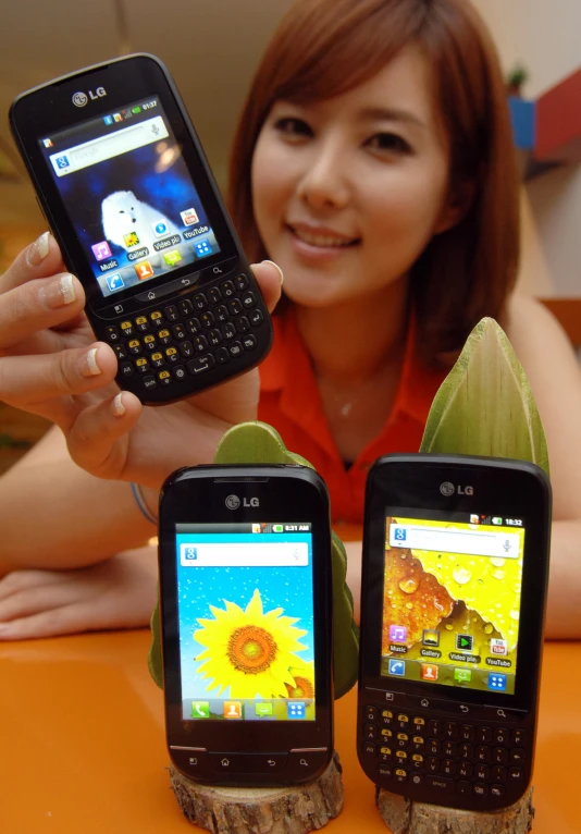 a woman with two smart phones in her hands