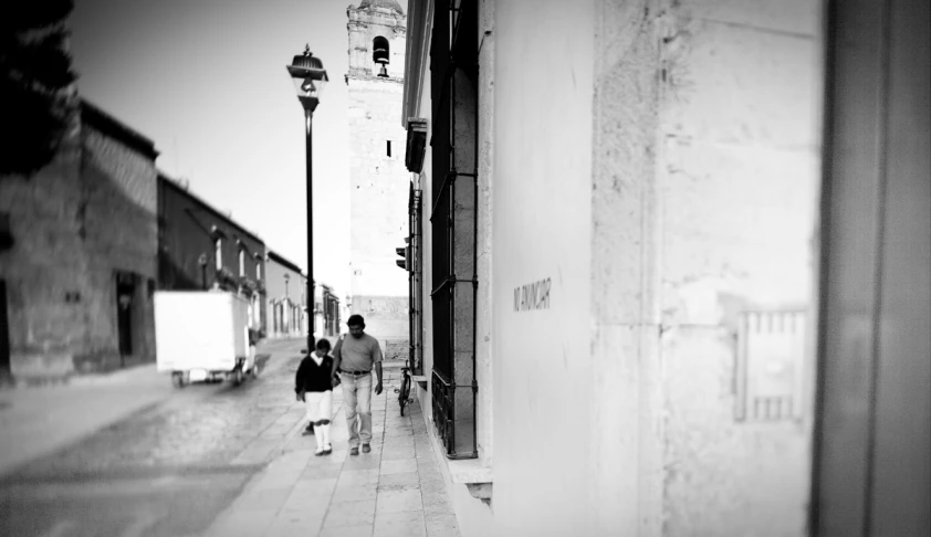 a black and white po of people walking down a street