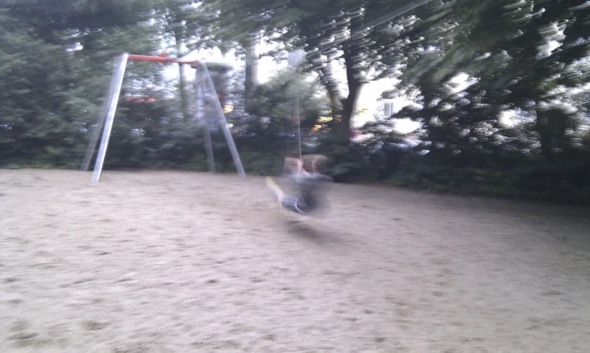 a person swinging a bat on the sand