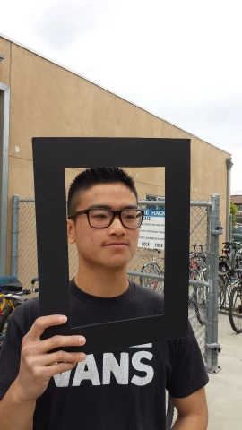 a man holding a po of his head framed