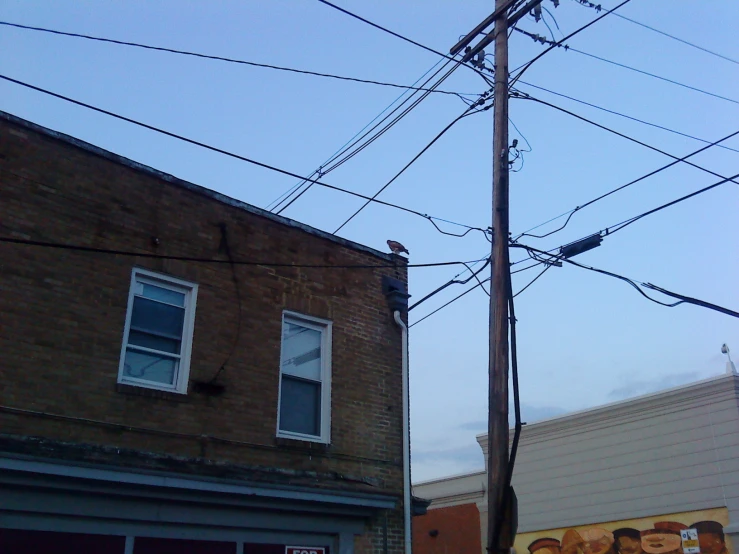 wires are hanging above the road and buildings