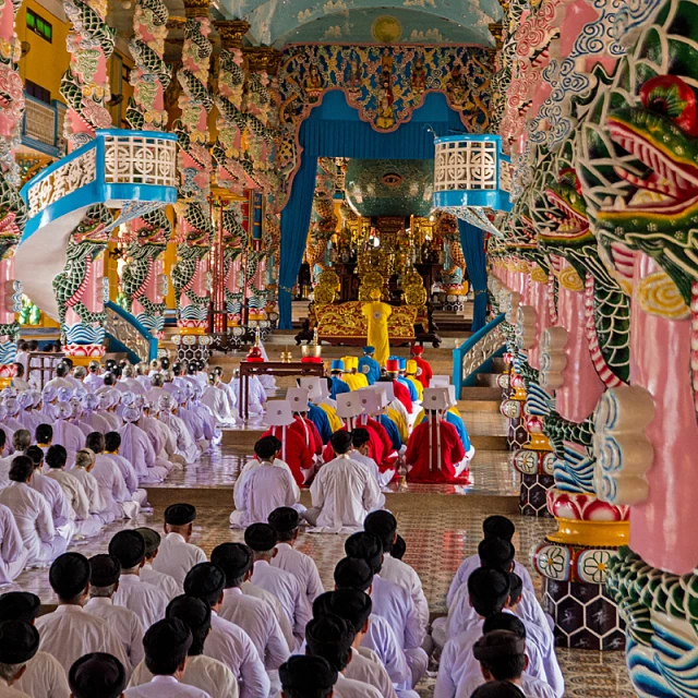 many people dressed in white are sitting in a group