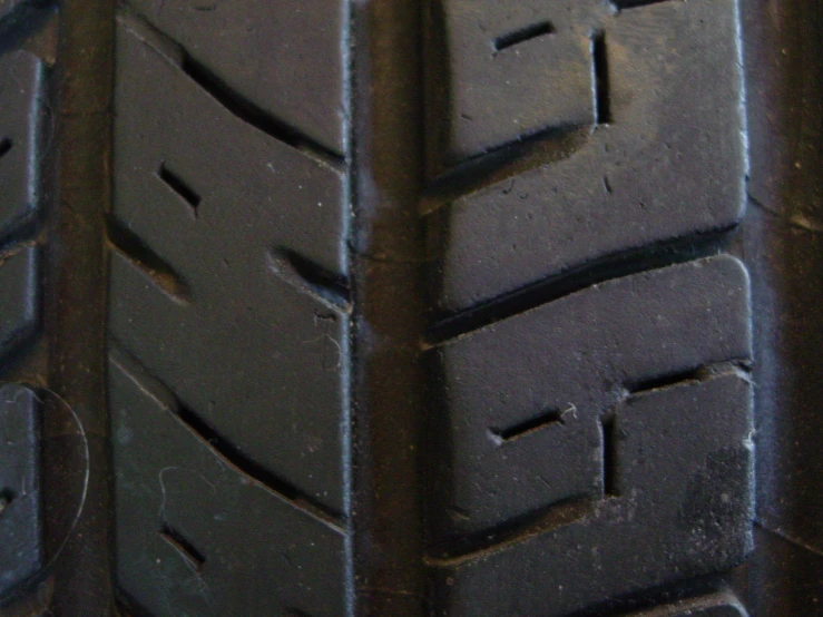 a close up of a very old tire tread